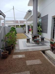a courtyard with benches and plants in a building at Kuantan Nadira Suite Homestay in Kuantan