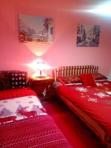 a bedroom with two beds and a table with a lamp at Guest House Cinderella in Herceg-Novi