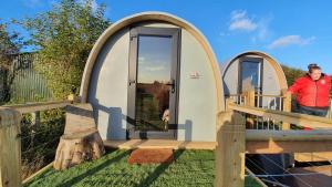 a tiny house with two arches on a deck at "PONY POD" at Nelson Park Riding Centre Ltd - GLAMPING POD also available the fox pod and Trailor Escapes- BIRCHINGTON, RAMSGATE, BROADSTAIRS MARGATE in Kent