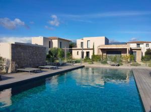 a large swimming pool in front of a house at Villa U Sanda in Lecci