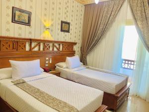 A bed or beds in a room at Teba Hotel Ras Elbar
