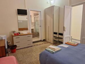 a bedroom with a bed and a dresser and a mirror at Guest House Erika in La Spezia +54 photos