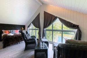 a living room with a bed and a large window at Reisa Lodge in Storslett