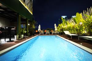 a swimming pool at night on a hotel at Prostyle Hotel Ho Chi Minh プロスタイルホテルホーチミン in Ho Chi Minh City
