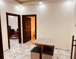 a room with a wooden table and a door at Dream Hotel jerash in Jerash +32 photos