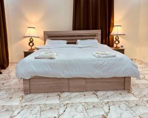 a bedroom with a large bed with two towels on it at Dream Hotel jerash in Jerash