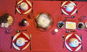 a table with plates of food on a red surface at La Bonauda in Valperga