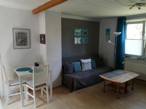 a living room with a couch and a table at Das Ferienhäusle in Utarp