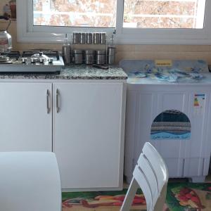 a kitchen with a stove and a washing machine at Imouzzar kandar in Imouzzer du Kandar