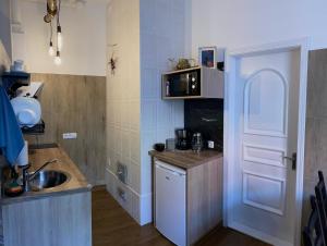 a small kitchen with a sink and a door at 555 метров до моря in Liepāja
