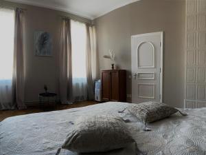 a bedroom with a large bed and a large window at 555 метров до моря in Liepāja