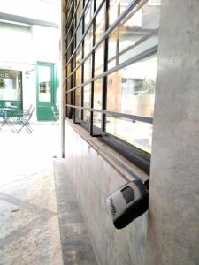 a security camera is on the side of a building at CKBSM Athens Center Apartment 2 in Athens