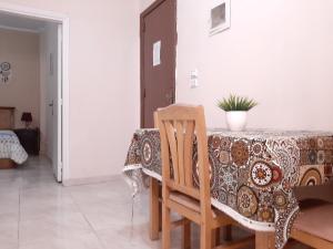 a dining room with a table and a chair at Family Apartment - Downtown Cairo in Cairo