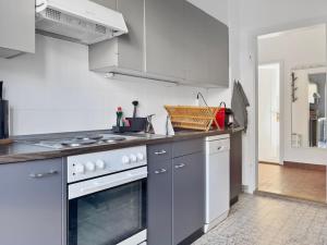 a white kitchen with a stove and a sink at Alpenzauber Suite für vier in Thun