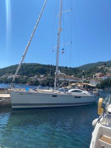 a sailboat docked at a dock in the water at Jeanneau Sun Odyssey 54 DS LULU’ in Nydri