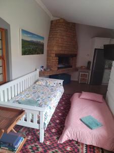 a bedroom with a bed and a brick fireplace at Worcester Garden Cottage in Worcester