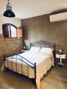 a bedroom with a bed and a wall at Villa Alberto in Sulmona