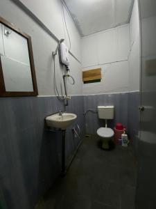a bathroom with a sink and a toilet at INTAN CHALEt in Pangkor