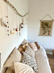 a bed with pillows on it in a room at The Smiling Buddha in Achthuizen