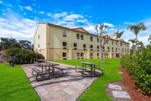 a building with tables and benches in a park at Quality Inn Sarasota I-75 in Sarasota