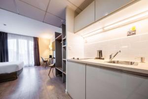 Posteľ alebo postele v izbe v ubytovaní Hôtel Quality Suites Maisons-Laffitte Paris Ouest