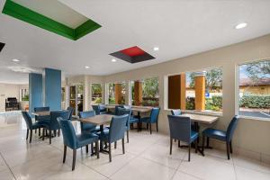 a dining room with tables and chairs and windows at Quality Inn Sarasota I-75 in Sarasota