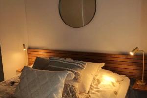 a bedroom with a bed with a mirror on the wall at Verso la casa mia in Helsinki