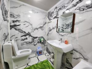 a bathroom with a black and white marble wall at Samani Bukhara in Bukhara +58 photos