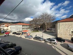 a street with cars parked on the side of the road at Chrysiida Apartments Kalavrita in Kalavrita