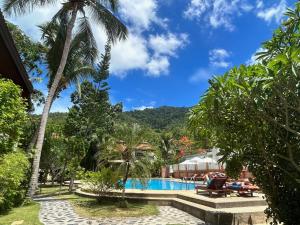a view of the pool at a resort with palm trees at Havana Beach Resort Phangan in Thong Nai Pan Yai