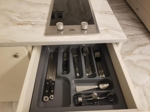 a drawer in a counter with knives and utensils at Segreto apartment 309, 311, 341 in Gudauri