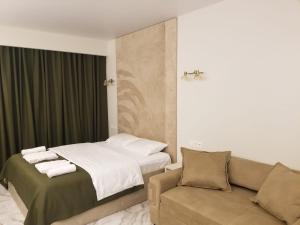 a hotel room with a bed and a couch at Segreto apartment 309, 311, 341 in Gudauri