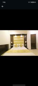 a bedroom with a large bed with two pillows at HOTEL AEROPATH INN in New Delhi