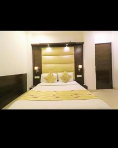 1 dormitorio con 1 cama blanca grande y 2 almohadas en HOTEL AEROPATH INN, en Nueva Delhi
