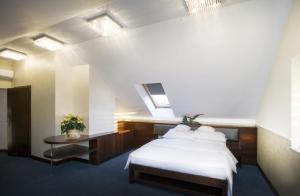 ビエラニ・ブロツワフスキエにあるHotel Interのベッドルーム(白いベッド1台、テーブル付)