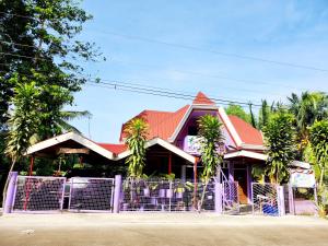 a building with a fence in front of it at Einel Homestay 2 in Siquijor