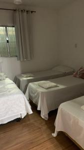 a room with two beds and a window at Sítio Maranata Vale das Montanhas in Monte Alegre do Sul