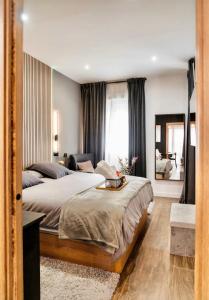 a bedroom with a large bed and a living room at Luxury and elegant apartment Madrid in Madrid