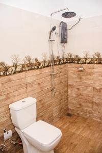 a bathroom with a toilet and a shower at Dien Dee Stays in Hikkaduwa