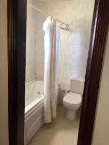 a bathroom with a toilet and a tub and a sink at Beautiful private villa Magawhish in Hurghada