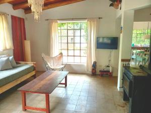 a living room with a couch and a table at Casa.Colibri.LaCumbre in La Cumbre