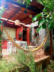 a hammock on the patio of a house at Casa.Colibri.LaCumbre in La Cumbre