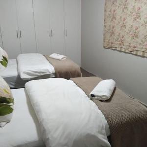 a room with two beds with towels on them at KarMichael Farm in Himeville