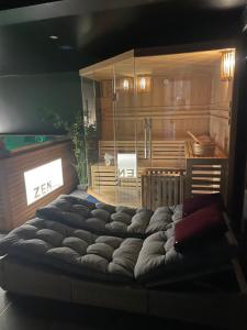 a large bed in the middle of a room at Linfinity in Baillonville