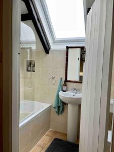 a bathroom with a sink and a bath tub and a sink at Sweet Lamb Farmhouse in New Ross