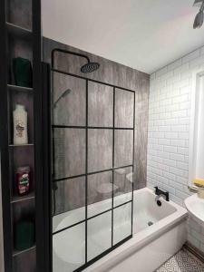 a bathroom with a shower and a bath tub at Home in Sheffield City Centre in Heeley