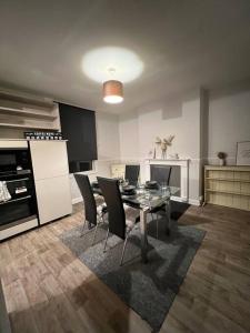 a kitchen with a dining room table and chairs at Home in Sheffield City Centre in Heeley