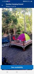 ein Zelt auf einer Holzbank mit zwei Stühlen in der Unterkunft Camping Ground @ Eastdee Lidlidda in Lidlidda