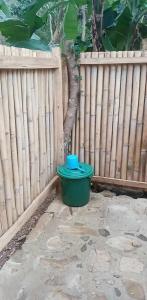 a green bucket sitting in front of a fence at Camping Ground @ Eastdee Lidlidda in Lidlidda