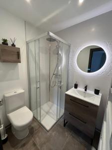 a bathroom with a shower and a toilet and a sink at Chalet La Tarine in Saint-Marcel +27 photos